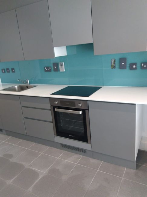 Beautiful pale blue kitchen splashback installed in a contemporary kitchen