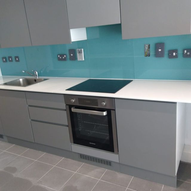 Beautiful pale blue kitchen splashback installed in a contemporary kitchen