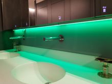 modern splashback with green lightening installed over a contemporary sink