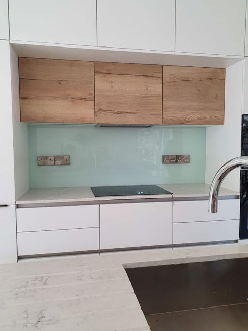 Pale blue glass splashback installed in a contemporary kitchen