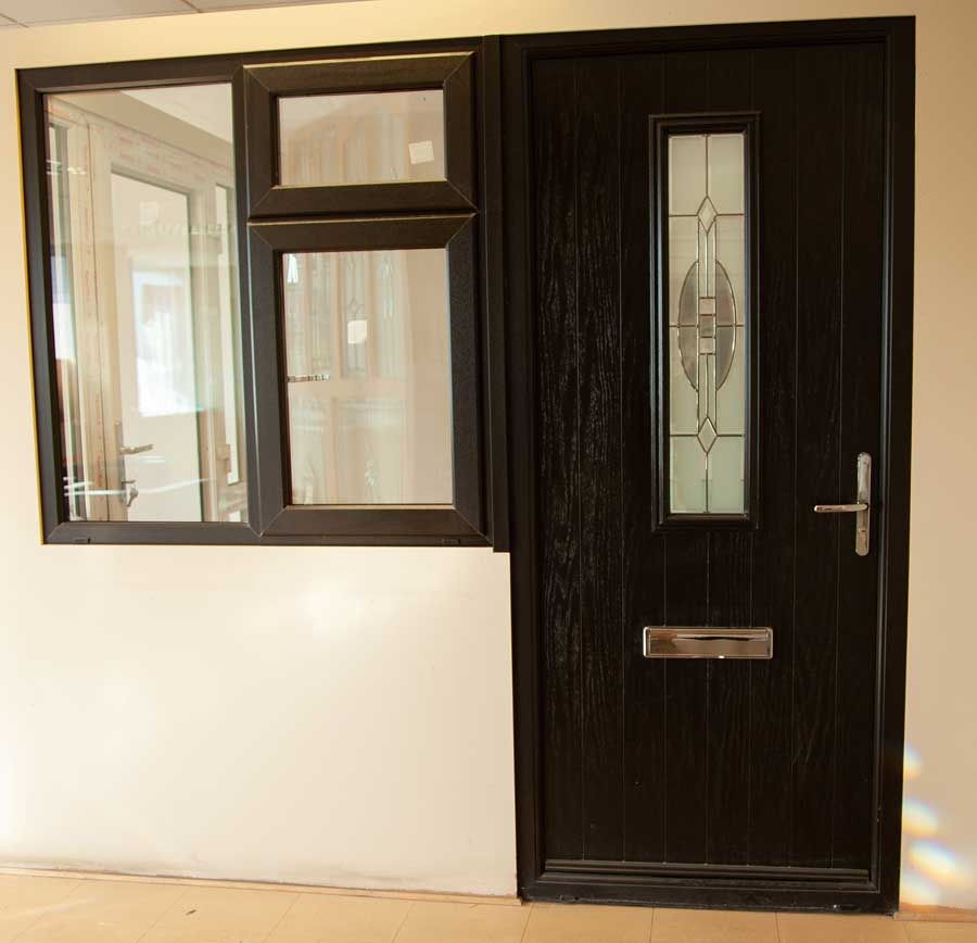 A front door with stained glass and newly installed glass in a window