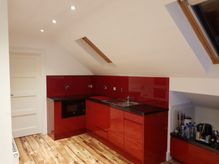Red kitchen spashback with matching cupboards 