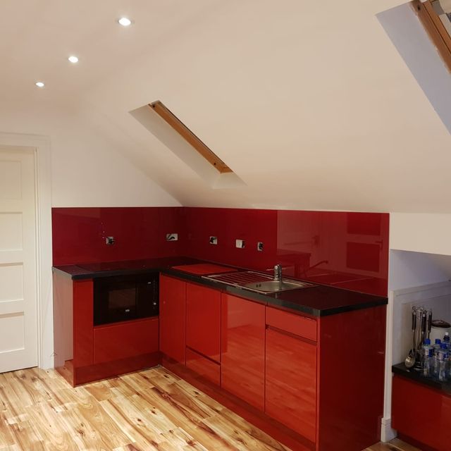 Red kitchen spashback with matching cupboards 
